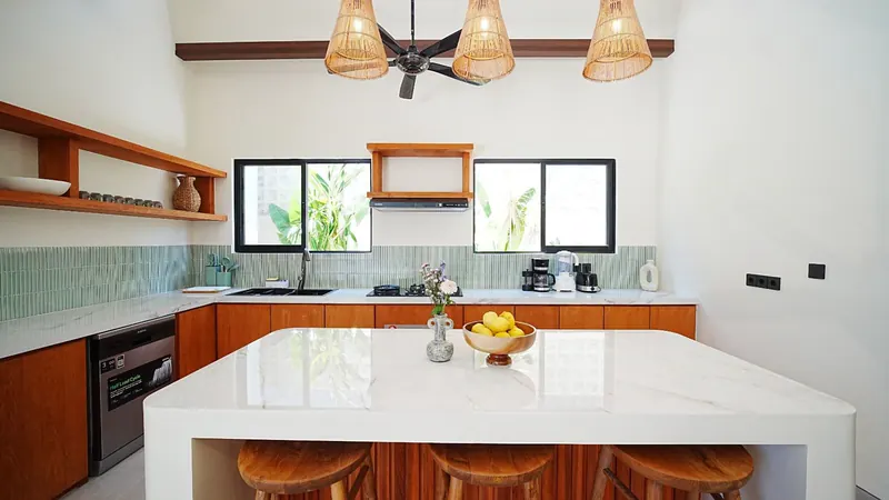 Bright villa kitchen in Bali with timber joinery and an island counter