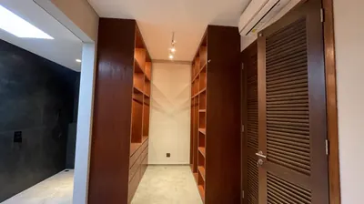 Custom built-in timber wardrobes with integrated lighting in a Bali home
