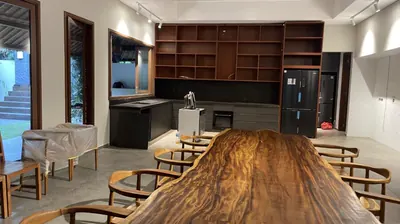Long live edge timber dining table in an open kitchen in Bali